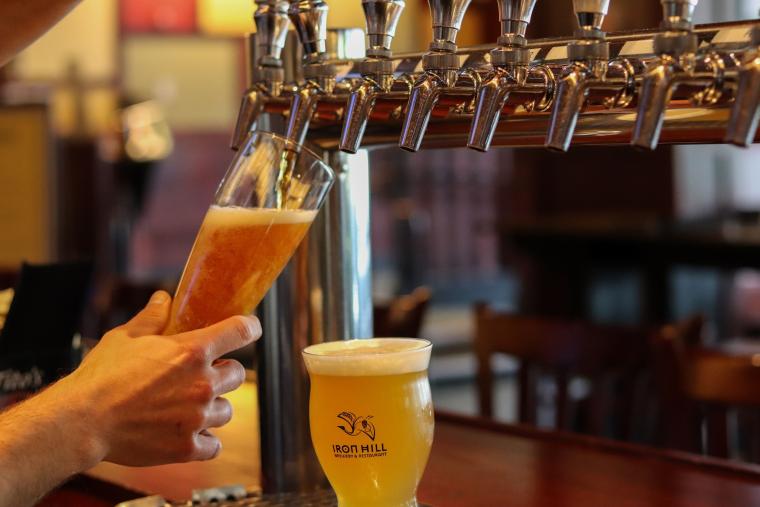 Beer being poured at Iron Hill Brewery