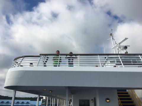 Two children looking over top railing to level below