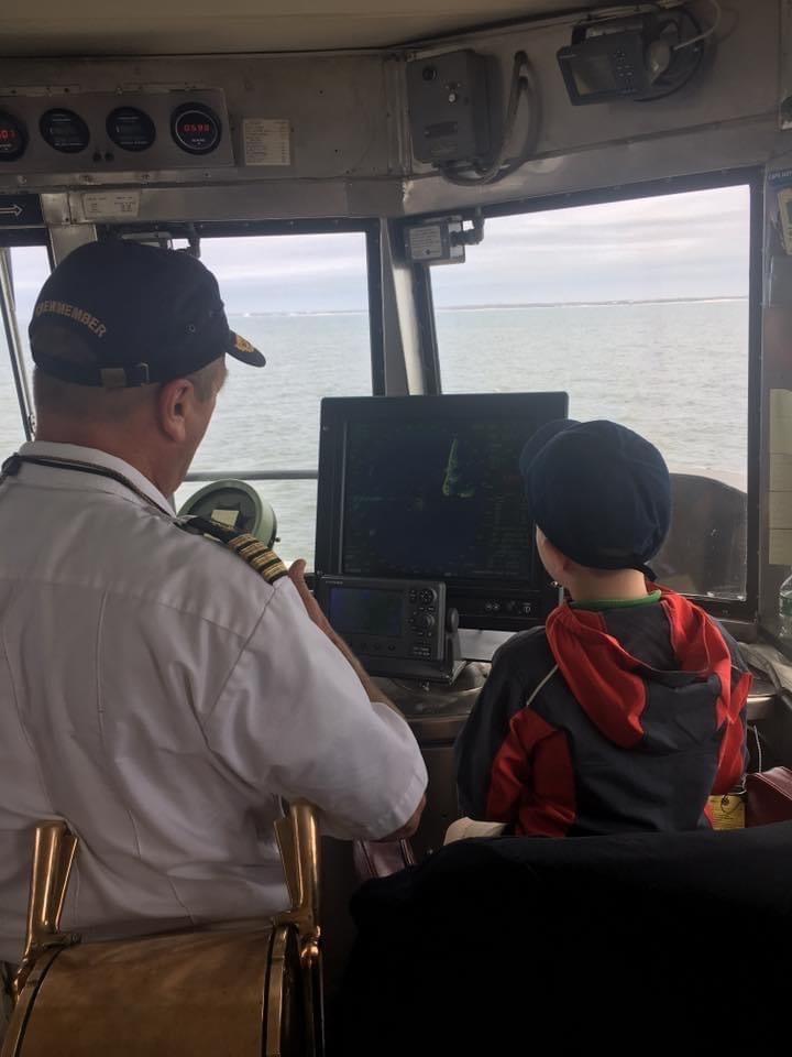Captain Vance training a young wound-be sailor on the Bridge