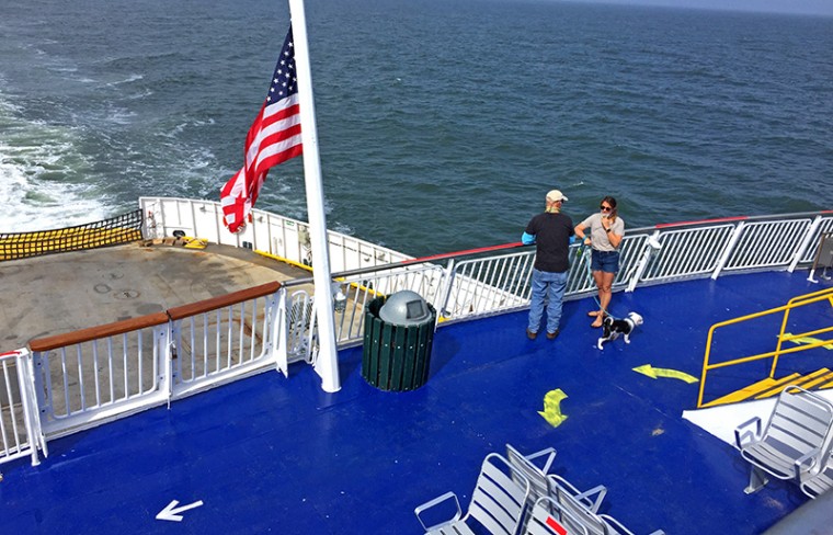 Passengers enjoying the exterior decks while wearing masks aboard the Cape May-Lewes Ferry