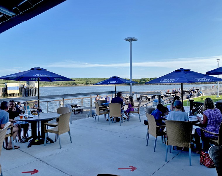 socially distanced seating with a waterfront view at On the Rocks in Cape May, NJ