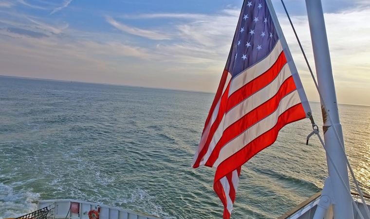 American flag flying over water view