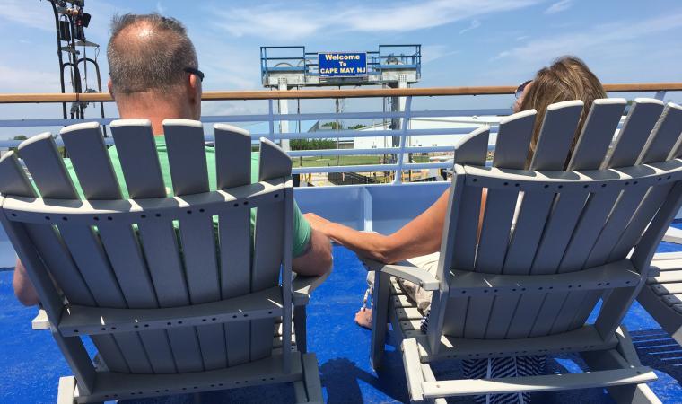 Couple sitting in chairs on ferry deck