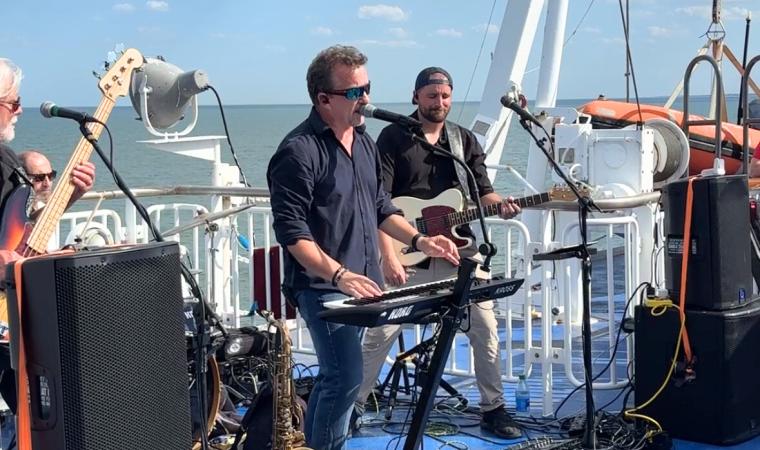 Glass Onion Band plating on board vessel for Rock the Boat