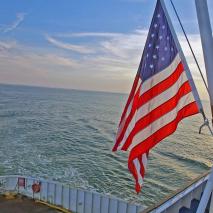 American flag flying over water view