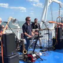 Glass Onion Band plating on board vessel for Rock the Boat
