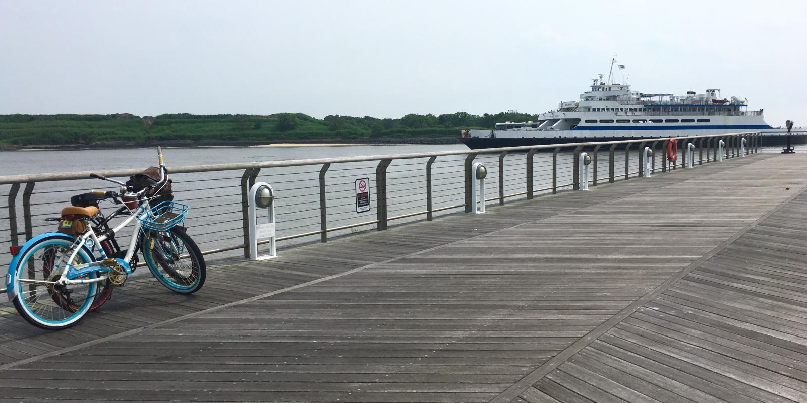 a bike on the dock as the ferry pulls in