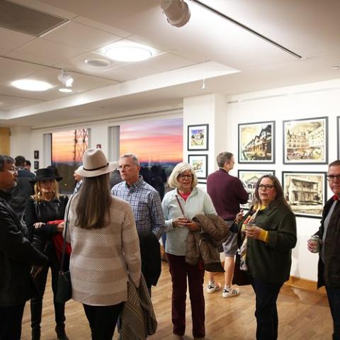 Spectators observing an exhibit at the Cape May Terminal Gallery