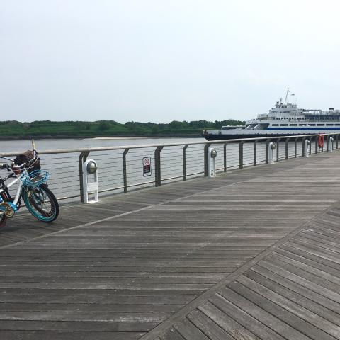 a bike on the dock as the ferry pulls in