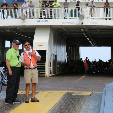 Ferry marine crew directing passengers during the boarding process for the Cape May-Lewes Ferry