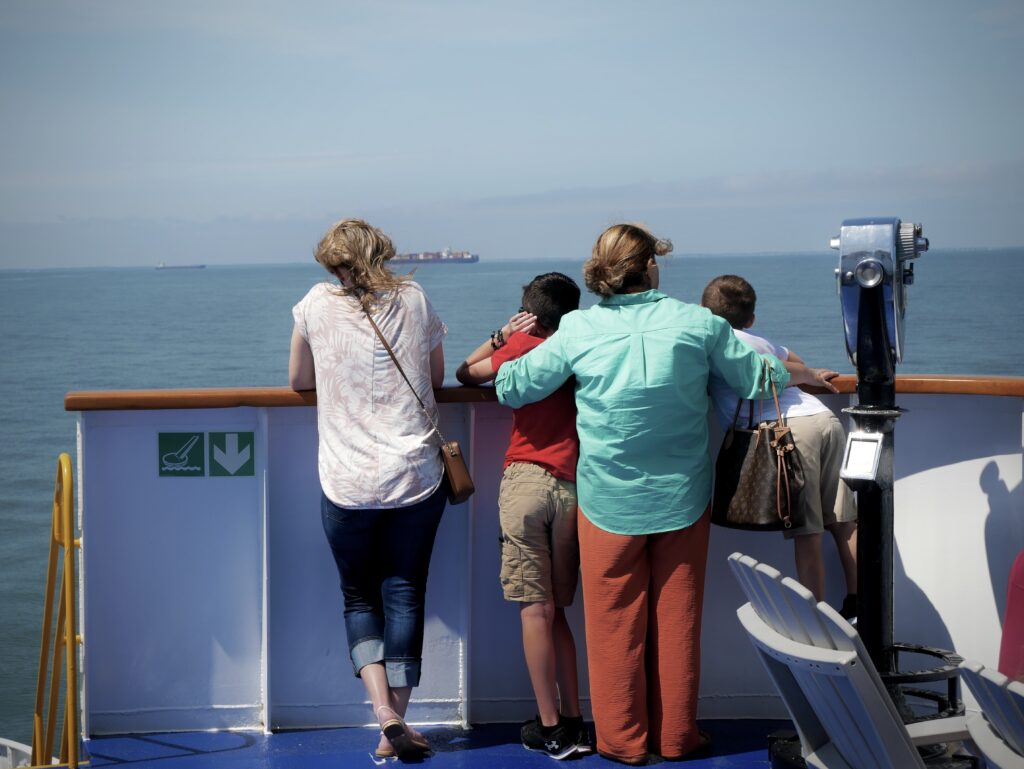 Two women and two children on the Cape May-Lewes ferry deck overlooking the Delaware Bay