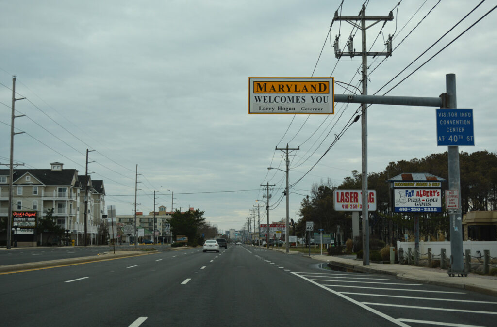 Road on MD-528 with a Maryland Welcomes You sign.