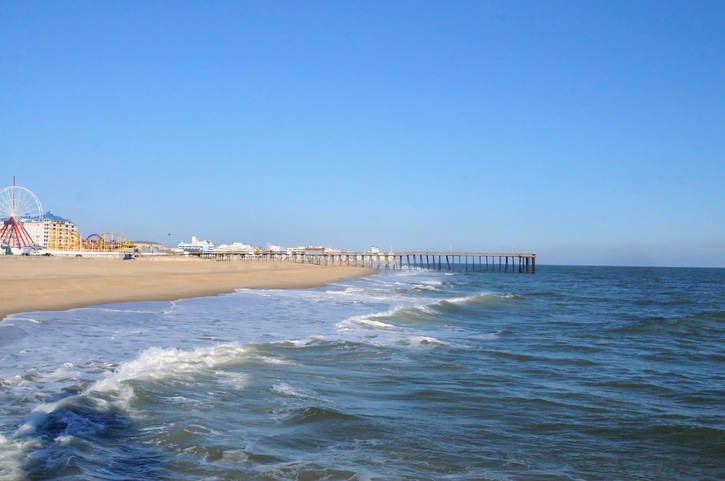 The combers roll ashore on a brilliant Christmas day at Ocean City, Maryland with the beach deserted and the sky a brilliant blu