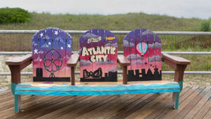 A group of three seats on the boardwalk in Atlantic City, New Jersey, promoting the city for the attraction of tourists.
