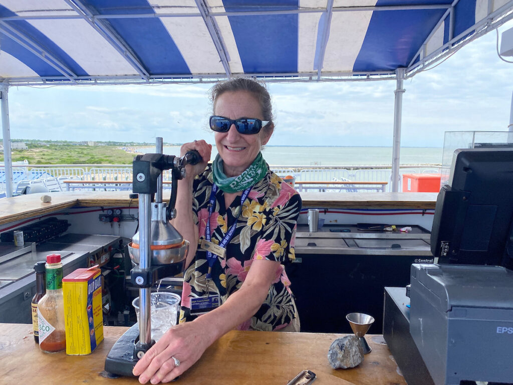 A bartender works for Food & Retail at the Lido Bar on MV Delaware