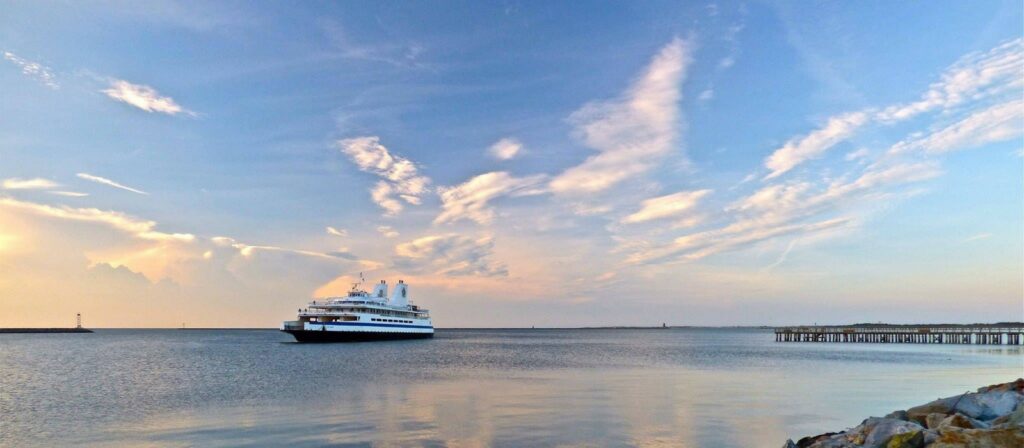 The ferry, backlit by a colorful sunset