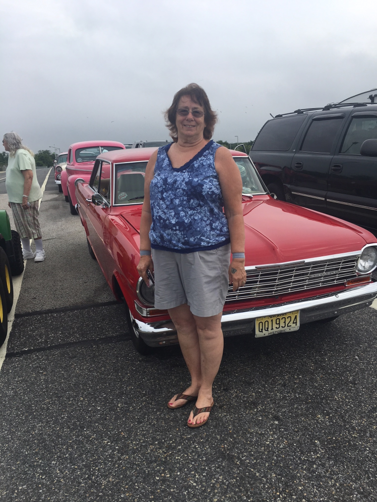 Sue McMurty stands infront to her Chevy Nova