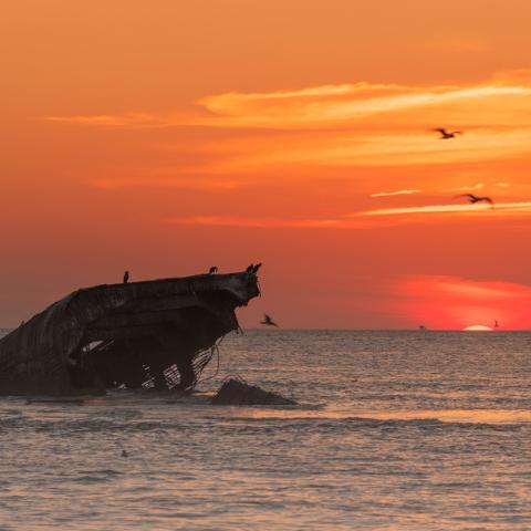 sunset over the sunken concrete ship