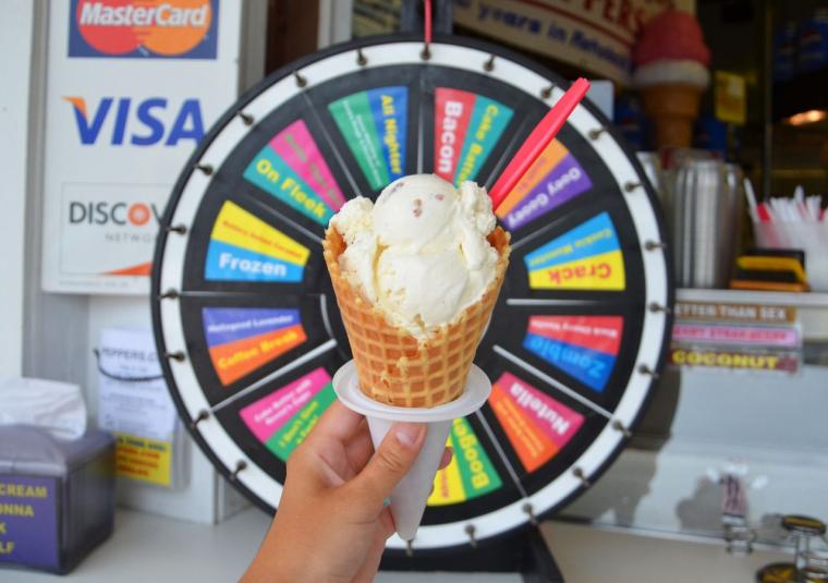 Ice cream cone held in front of a gameshow-style flavor wheel