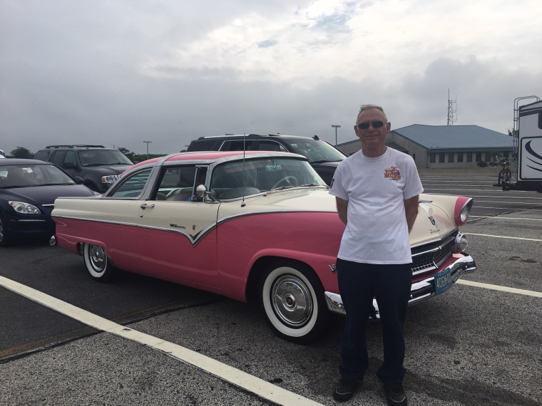 Vic Merrill stands next to his Crown Victoria