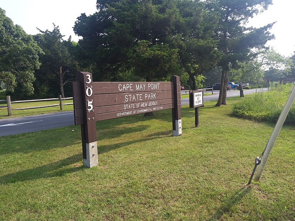 Entrance sign for Cape May Point State Park at 305 Lighthouse Ave, Cape May Point, NJ, managed by the New Jersey Department of Environmental Protection. Photo by WhisperToMe (https://commons.wikimedia.org/wiki/File:Cape_May_Point_State_Park.jpg) , CC0, via Wikimedia Commons.