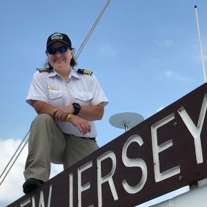 Cape May - Lewes Ferry Captain Melissa Velli posing in uniform on top of the New Jersey vessel