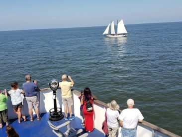 People on board the Ferry view New Jersey's Official Tall Ship the AJ Meerwald sails on Delaware Bay while based at the Cape May Terminal Port