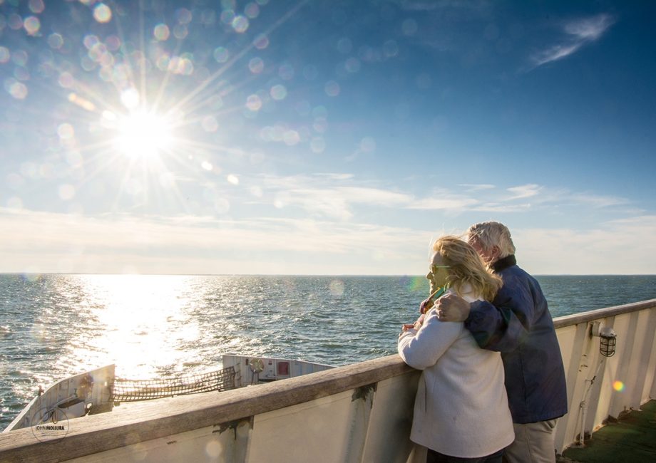 Couple looking out over the sunny view during the winter season